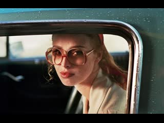 lady with glasses and a gun in a car 2015